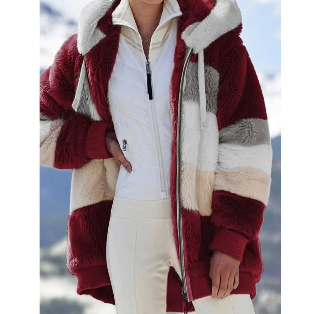 Person wearing a red and white fur-lined coat with a blurred outdoor background