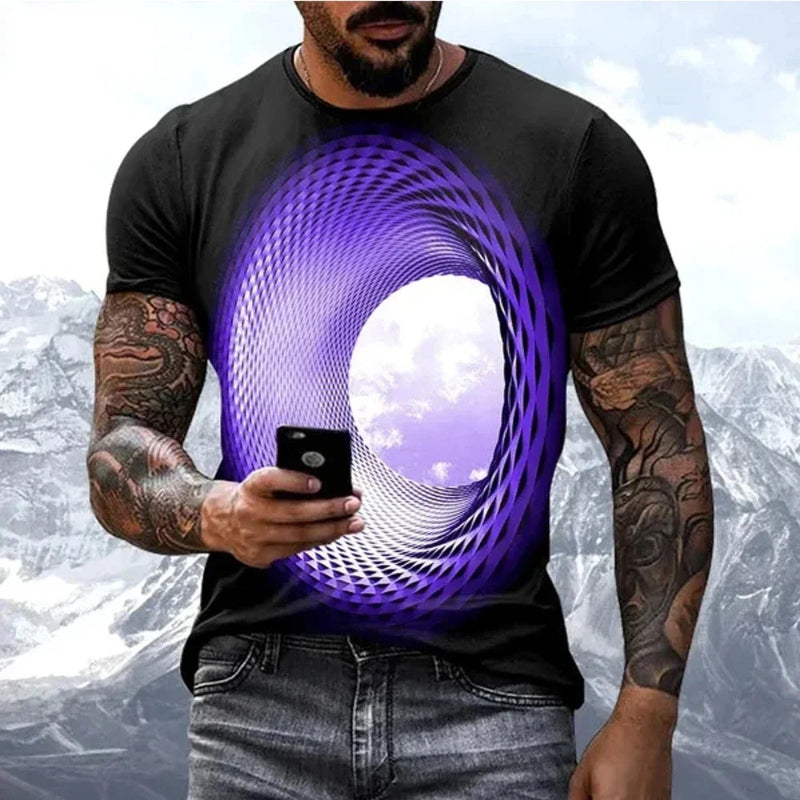 Man wearing a black t-shirt with a purple abstract design, holding a phone with a mountainous background.