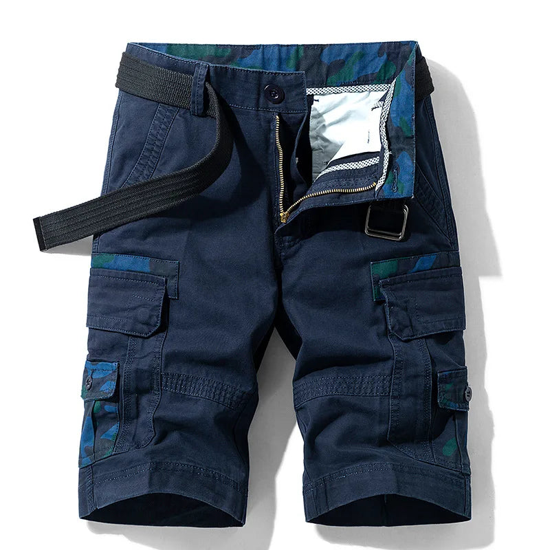Navy blue cargo shorts with multiple pockets and zippers on a white background