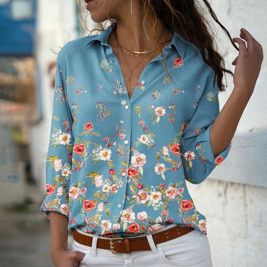Woman wearing a blue floral shirt with a blurred background