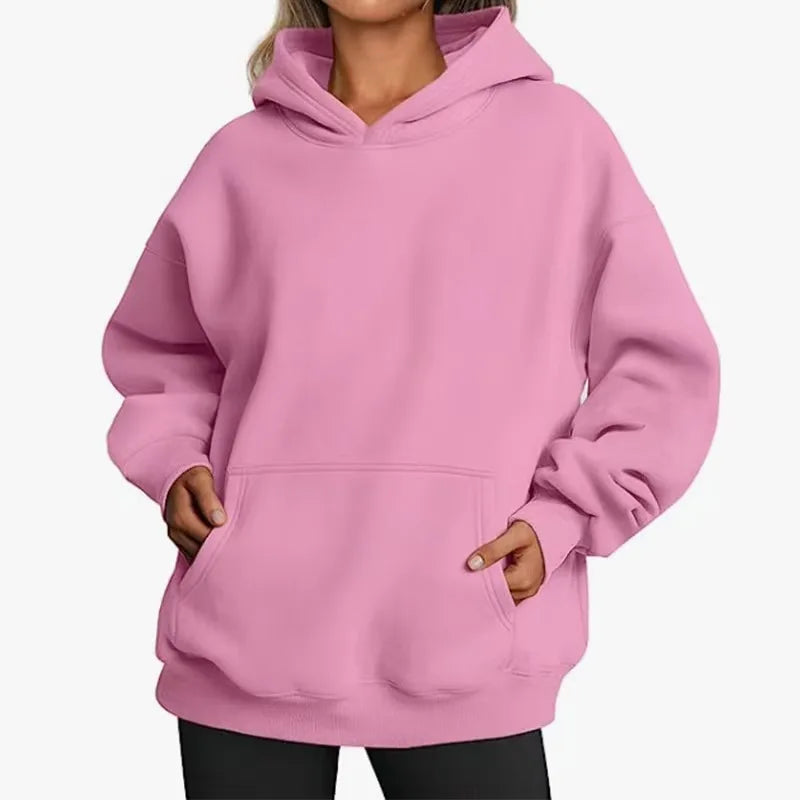 Pink hoodie worn by a person on a white background