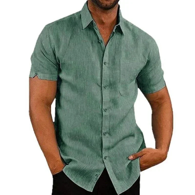 Green short-sleeve shirt worn by a person on a white background