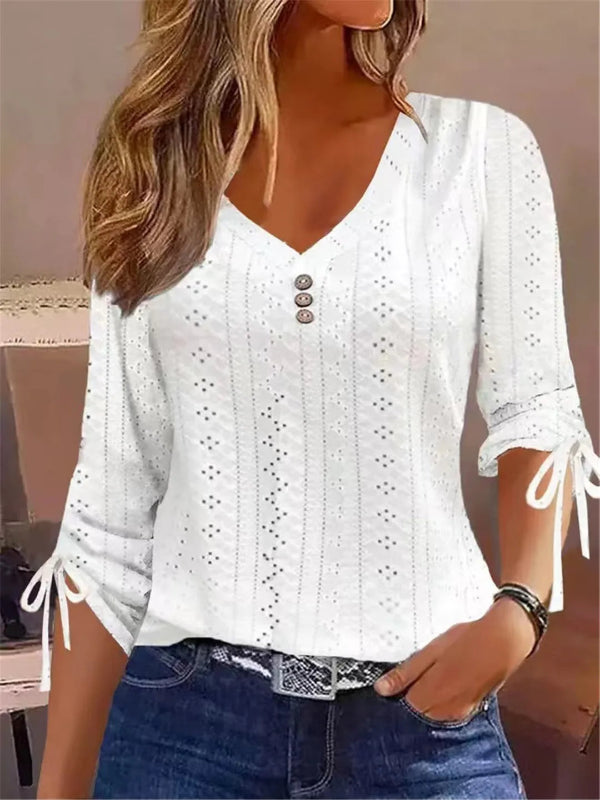 White lace top worn by a person with a neutral background