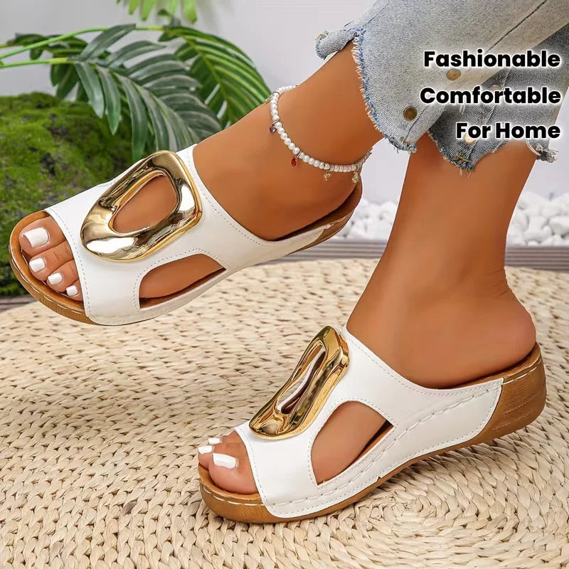 White sandals with gold accents worn by a person on a woven surface, with text 'Fashionable Comfortable For Home'.