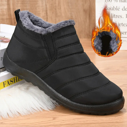 Black winter boot with gray fur lining on a wooden surface