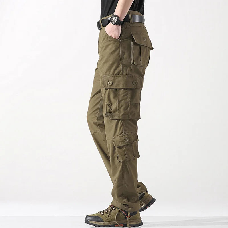 Green cargo pants worn by a person on a white background