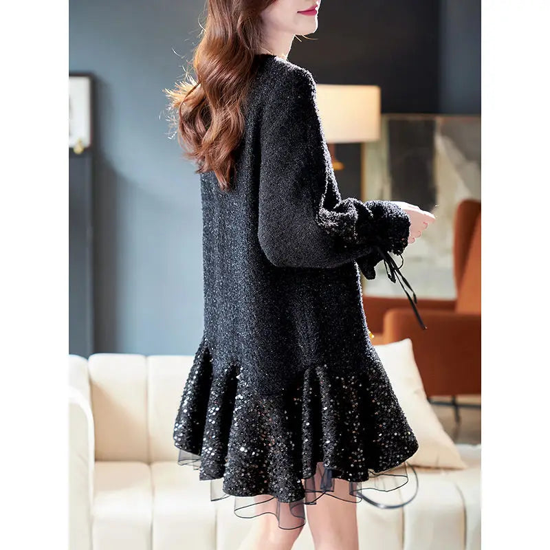 Woman wearing a black sequin dress in an indoor setting