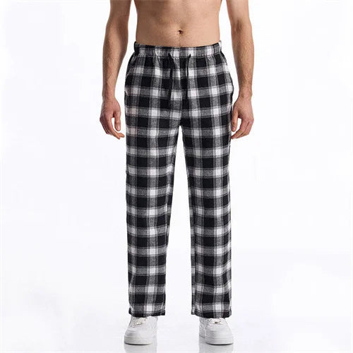 Black and white plaid pajama pants worn by a person on a white background