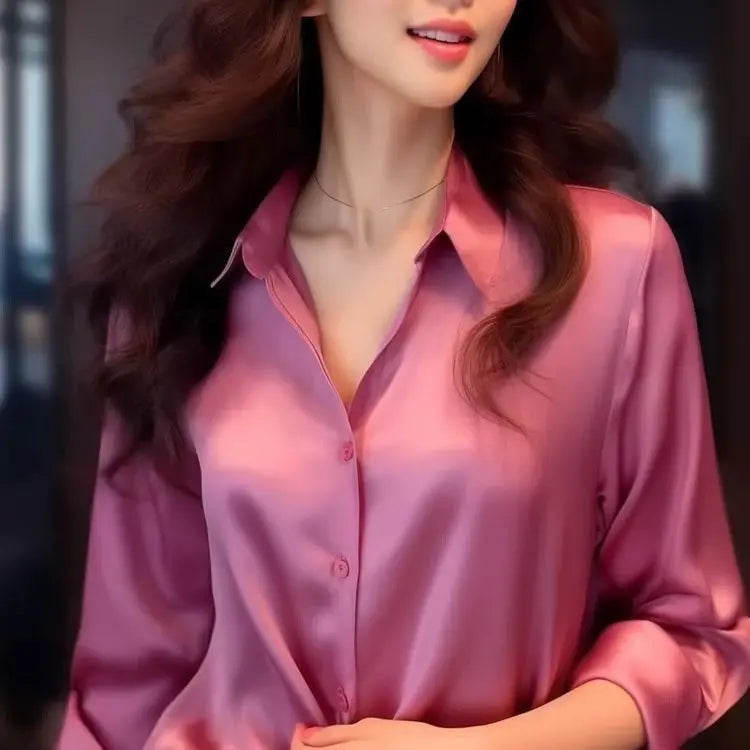 Woman wearing a pink satin shirt with a blurred background