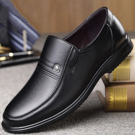 Black leather shoe on a textured surface with a blurred background