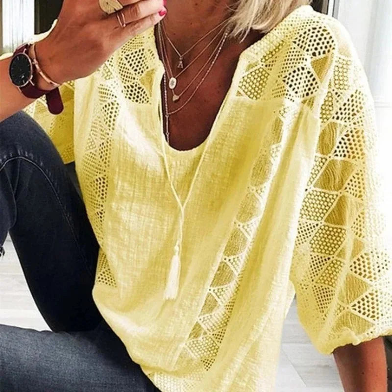 Person wearing a yellow crochet top with a blurred background