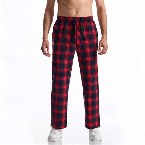 Red and black plaid pants worn by a person on a white background