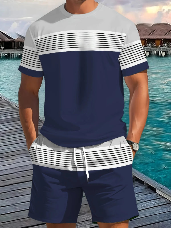 Man wearing a navy and white striped shirt with matching shorts by a waterfront.