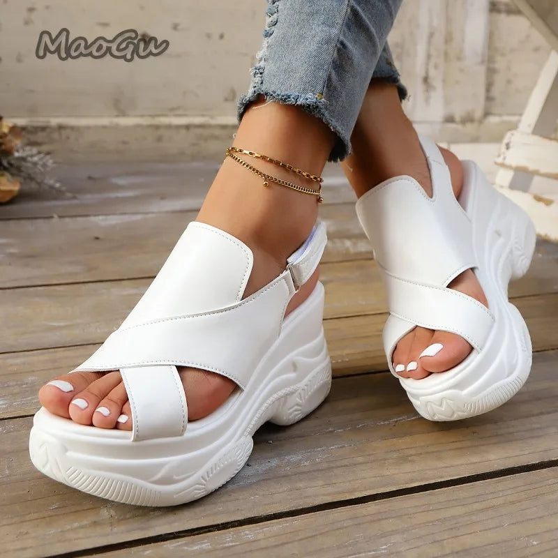 White platform sandals worn on a wooden floor with 'MaoGiu' branding.