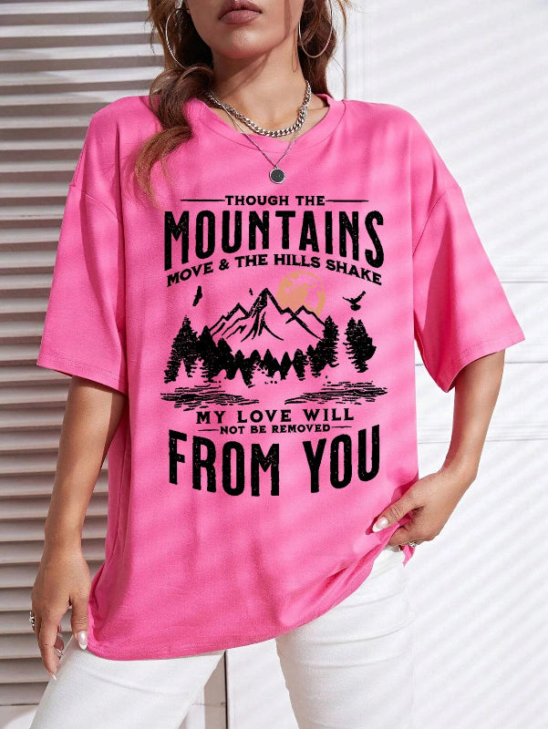 Person wearing a pink t-shirt with a mountain design and text.