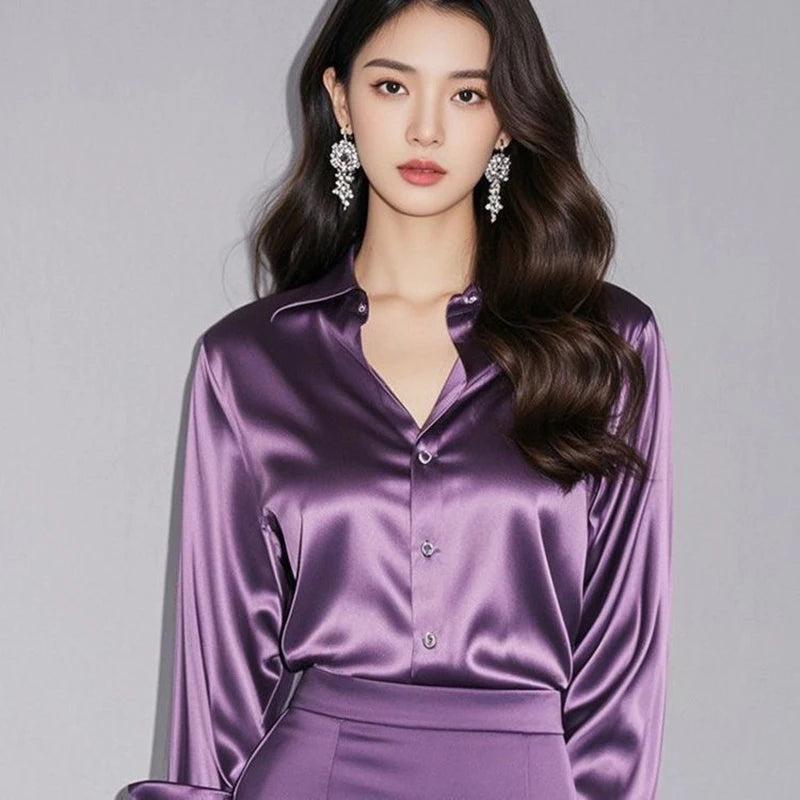 Woman wearing a purple satin outfit against a gray background