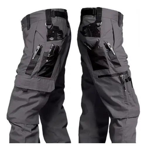 Gray tactical pants with multiple pockets and zippers on a white background