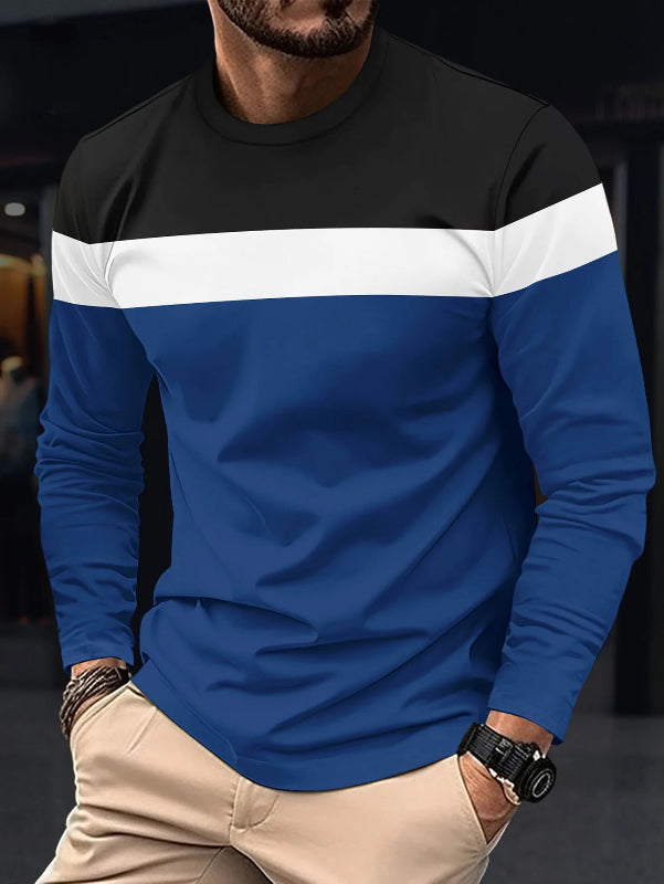 Person wearing a black and blue long-sleeve shirt with a blurred background