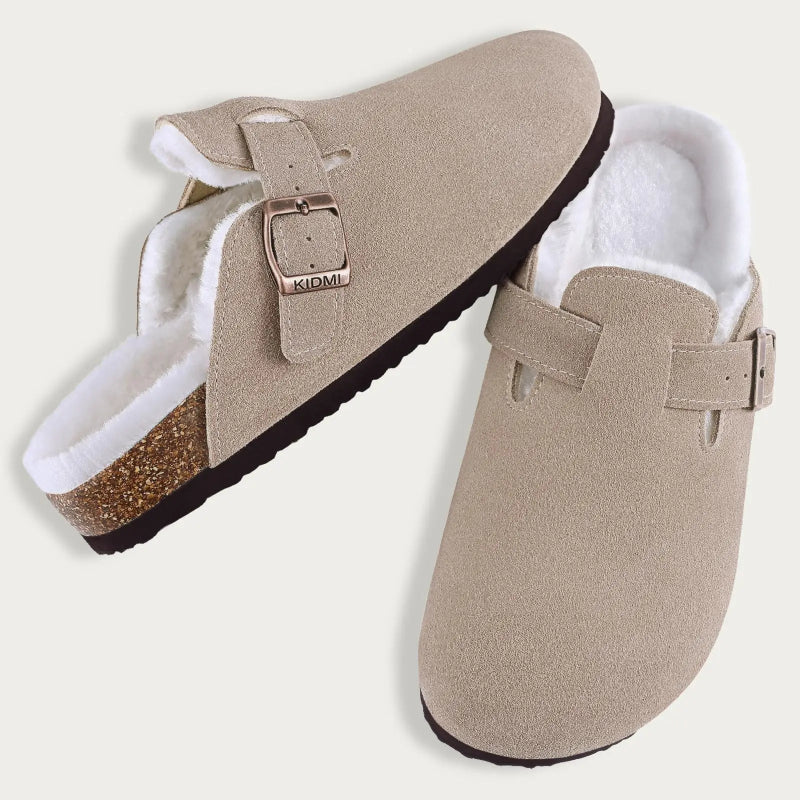 Pair of beige slippers with white lining and buckles on a light gray background