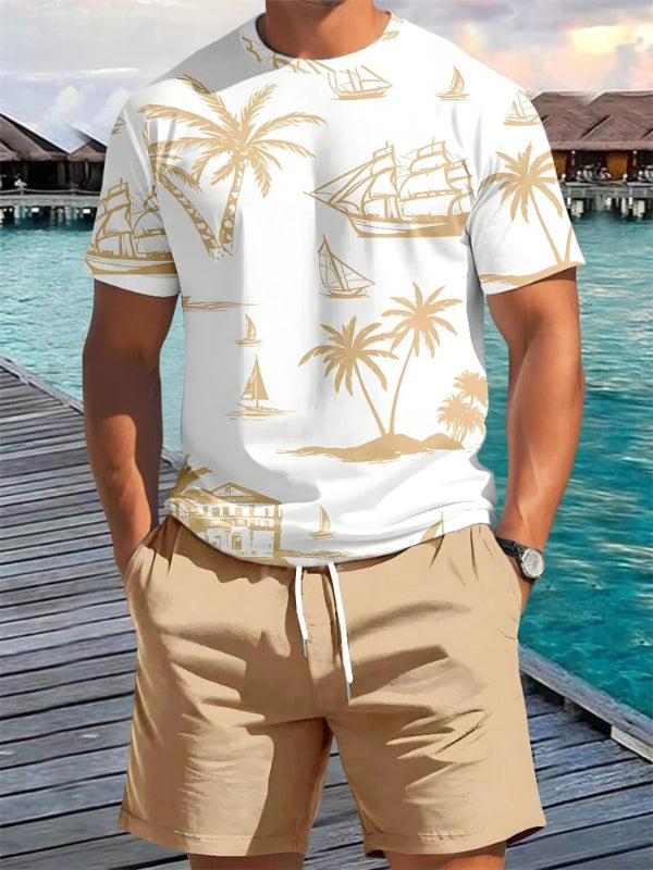 Person wearing a white t-shirt with gold palm tree and ship pattern and beige shorts by a waterfront.