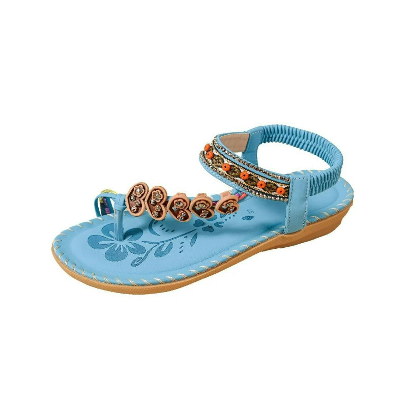 Blue sandal with decorative straps on a white background