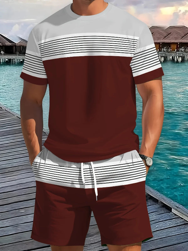 Person wearing a maroon and white striped shirt with shorts by a waterfront.
