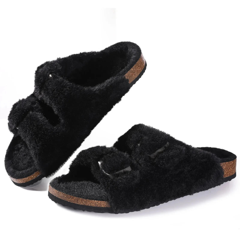Black fuzzy slippers with brown soles on a white background
