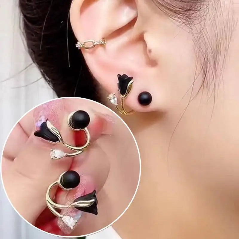 Close-up of an ear wearing a black and gold earring with a magnified inset detail.