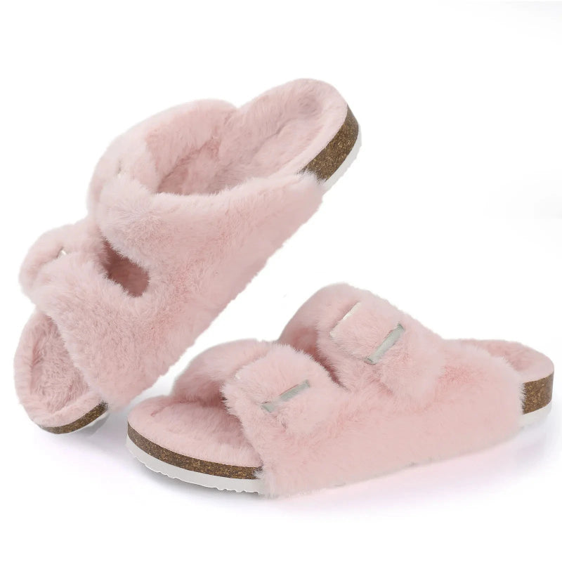 Pair of pink fuzzy slippers on a white background