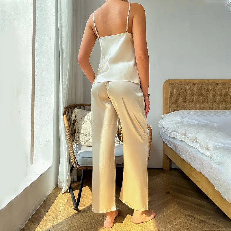 Person wearing a satin pajama set in a bedroom.
