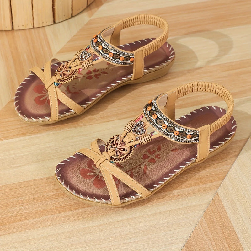 Pair of decorative sandals on a wooden surface