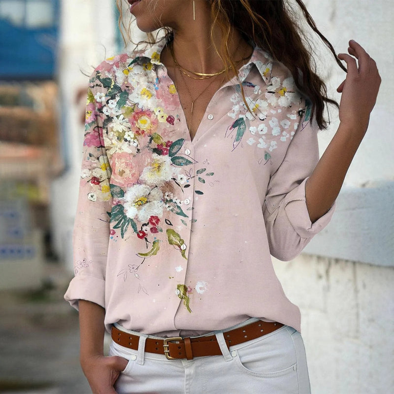 Woman wearing a pink floral blouse with a blurred background