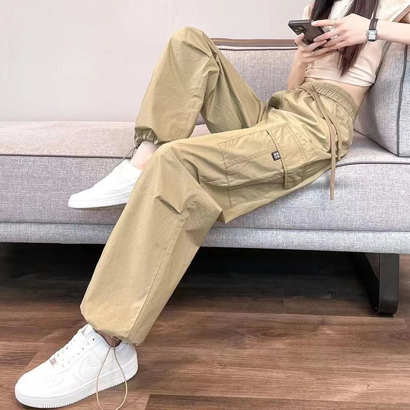 Person wearing beige cargo pants sitting on a couch.