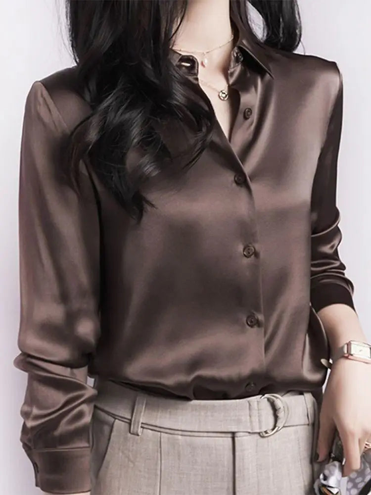 Brown satin blouse worn by a person on a white background