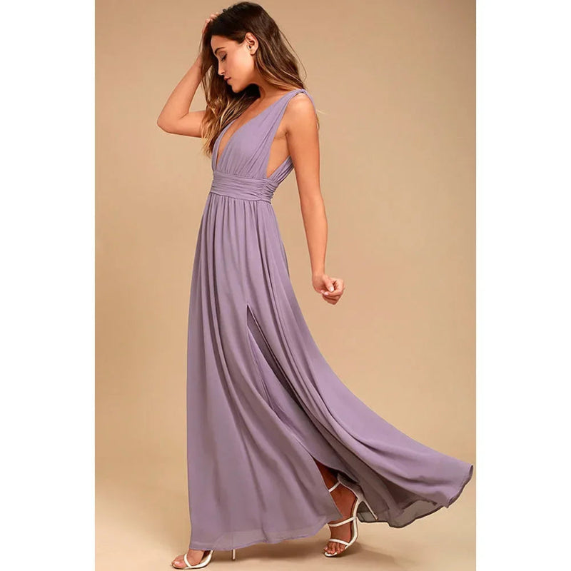 Woman wearing a long purple dress against a beige background