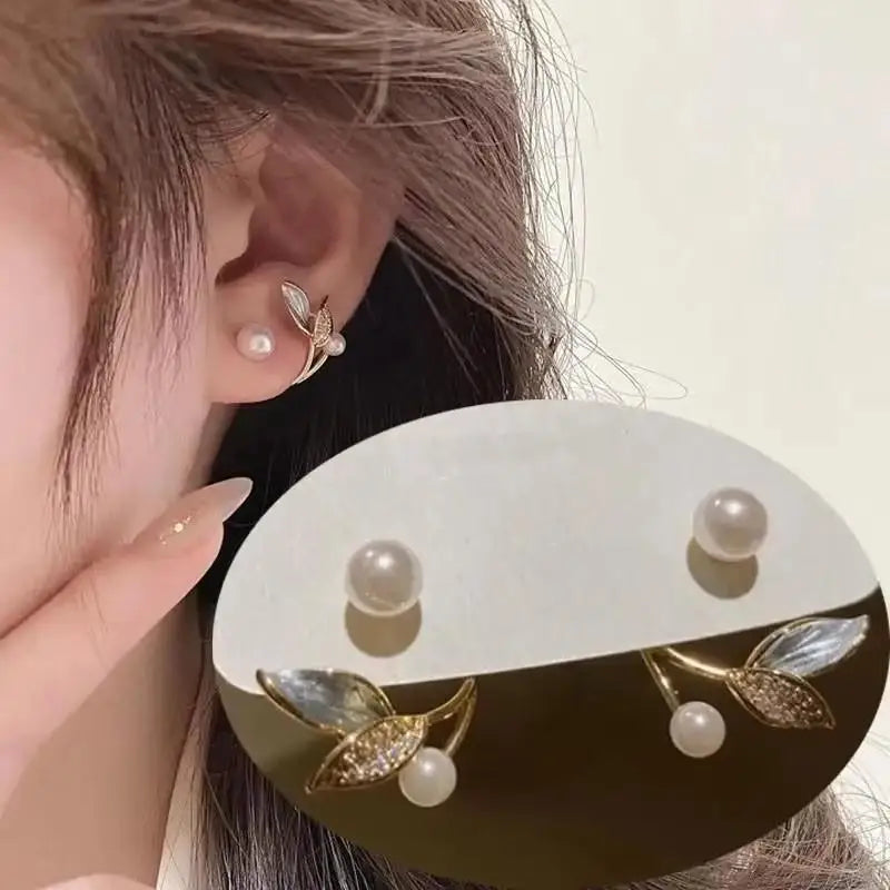 Close-up of an ear wearing a pearl earring with a white background