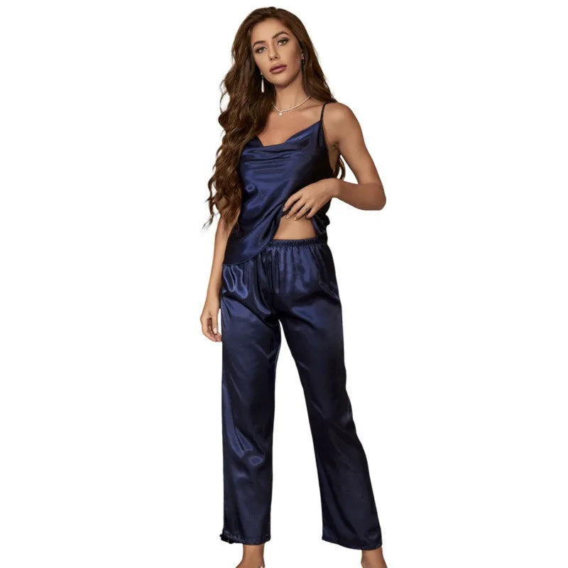 Woman wearing a navy satin pajama set on a white background