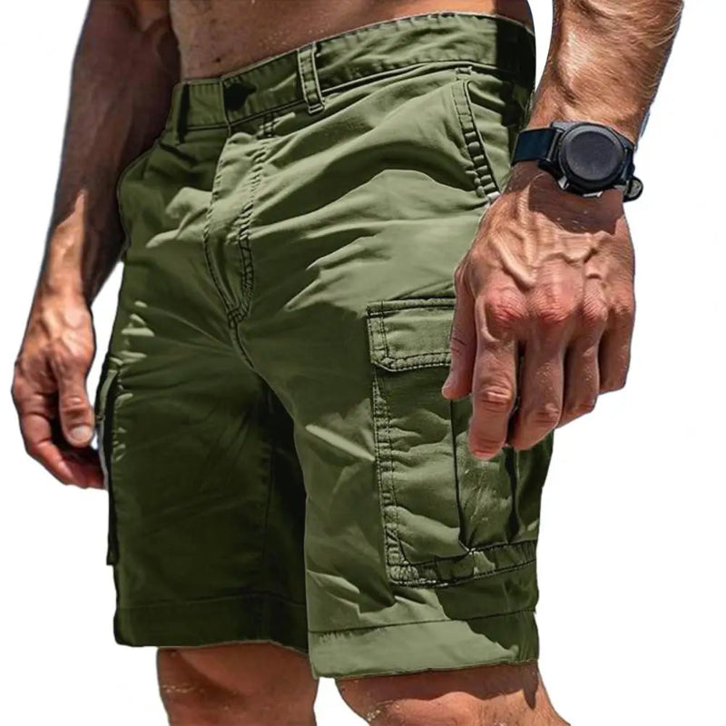 Green cargo shorts worn by a person on a white background