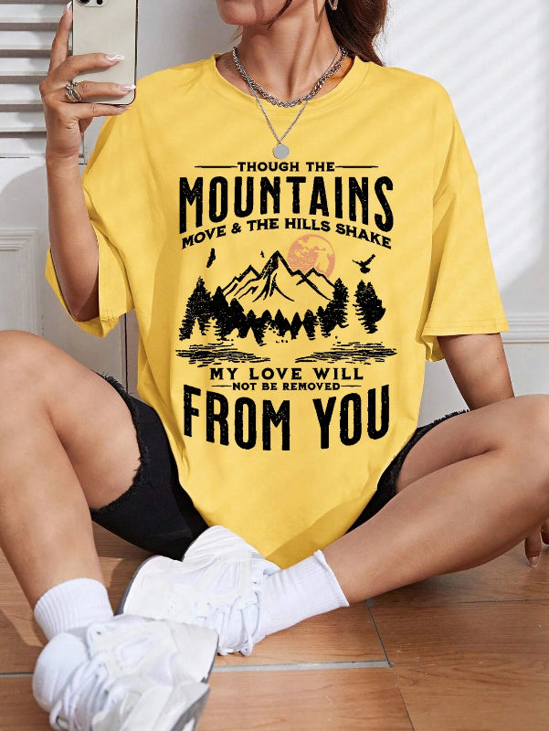 Person wearing a yellow t-shirt with a mountain design and text.