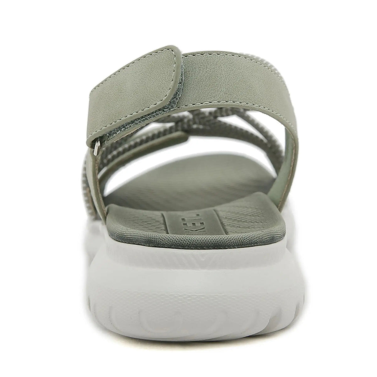 Green sandal with a white sole on a white background