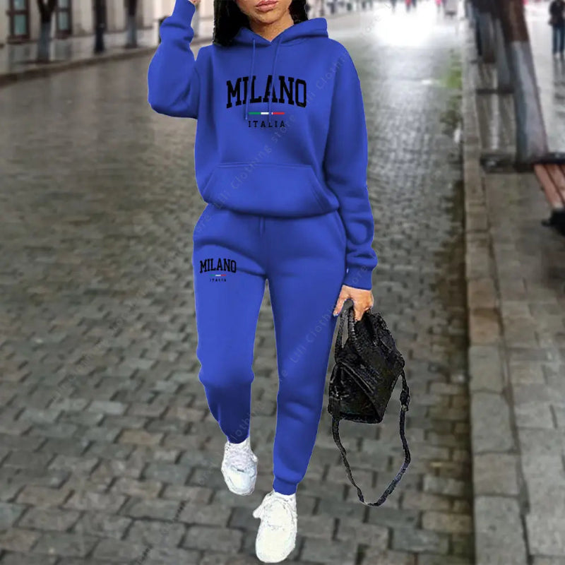 Person wearing a blue 'Milano' tracksuit on a city street.