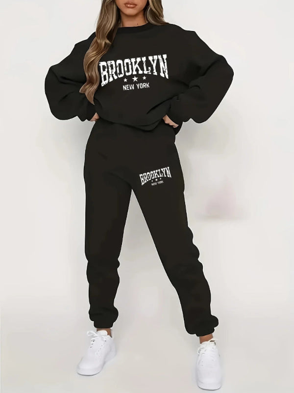 Black 'Brooklyn New York' sweatshirt and jogger set worn by a person on a white background
