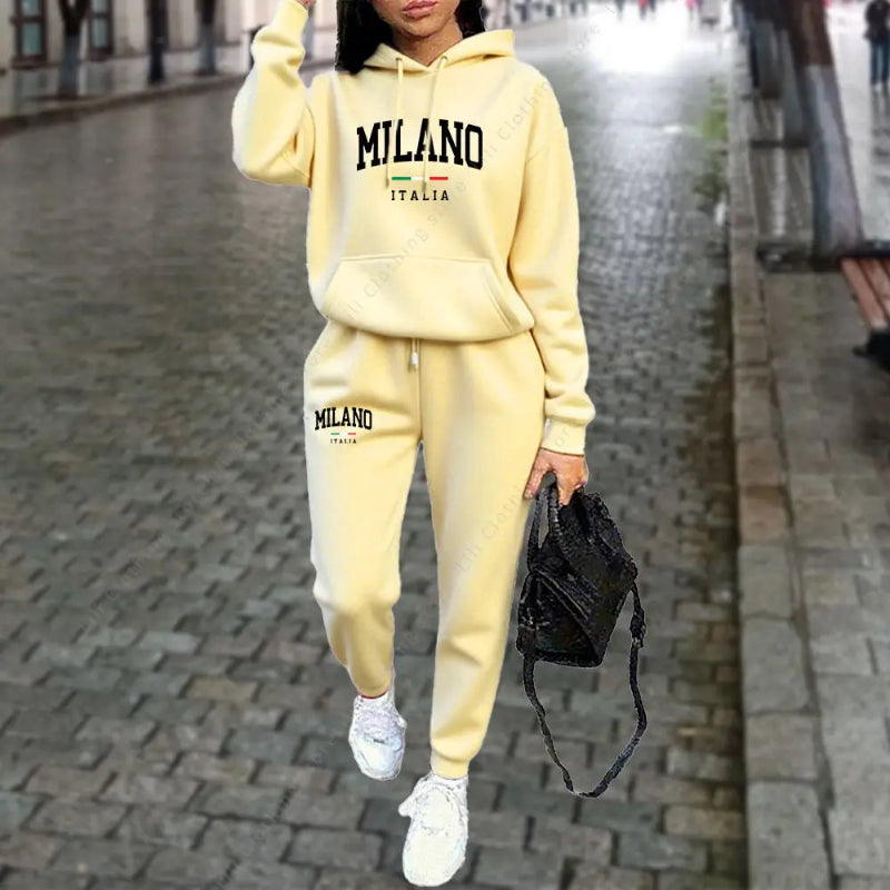 Person wearing a yellow 'Milano Italia' tracksuit on a city street.