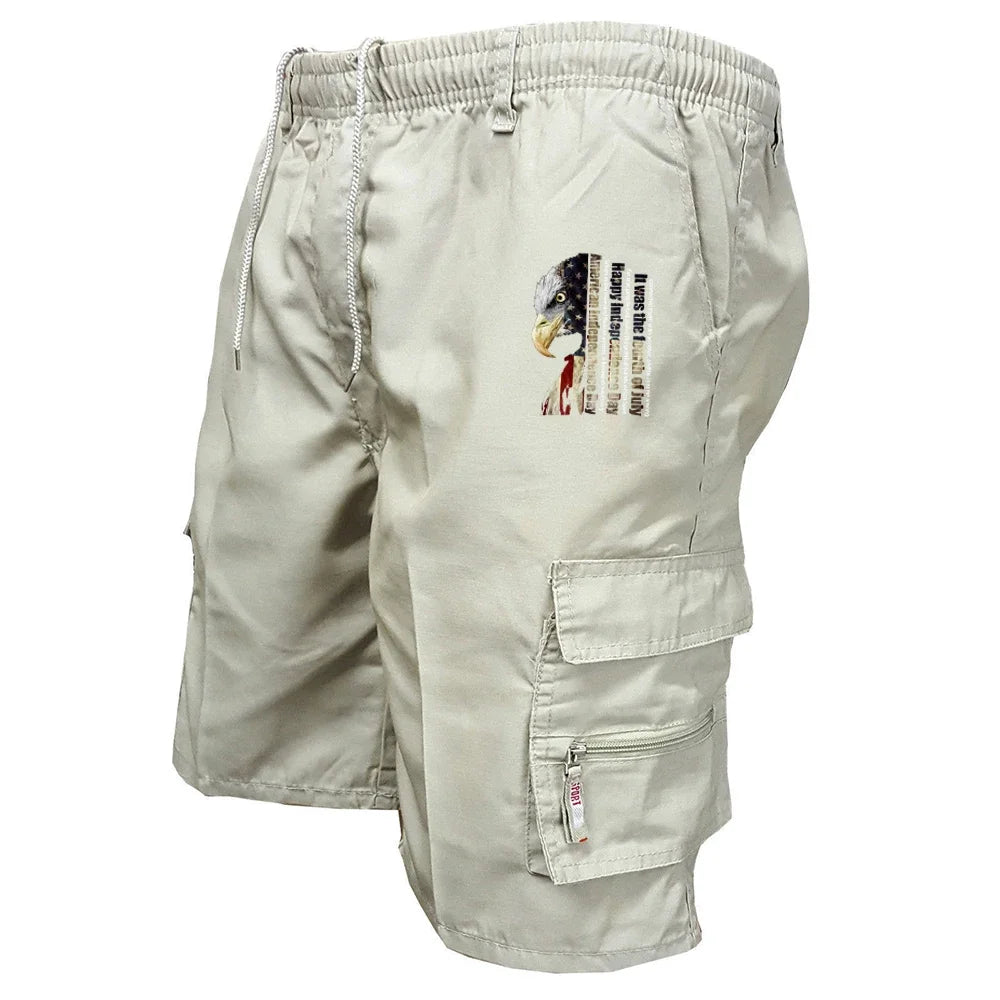 Beige cargo shorts with an eagle and flag design on a white background