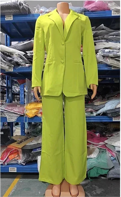 Mannequin wearing a bright green suit in an indoor setting with shelves and items in the background.