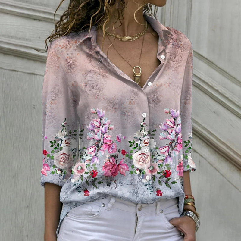 Woman wearing a floral blouse with a neutral background