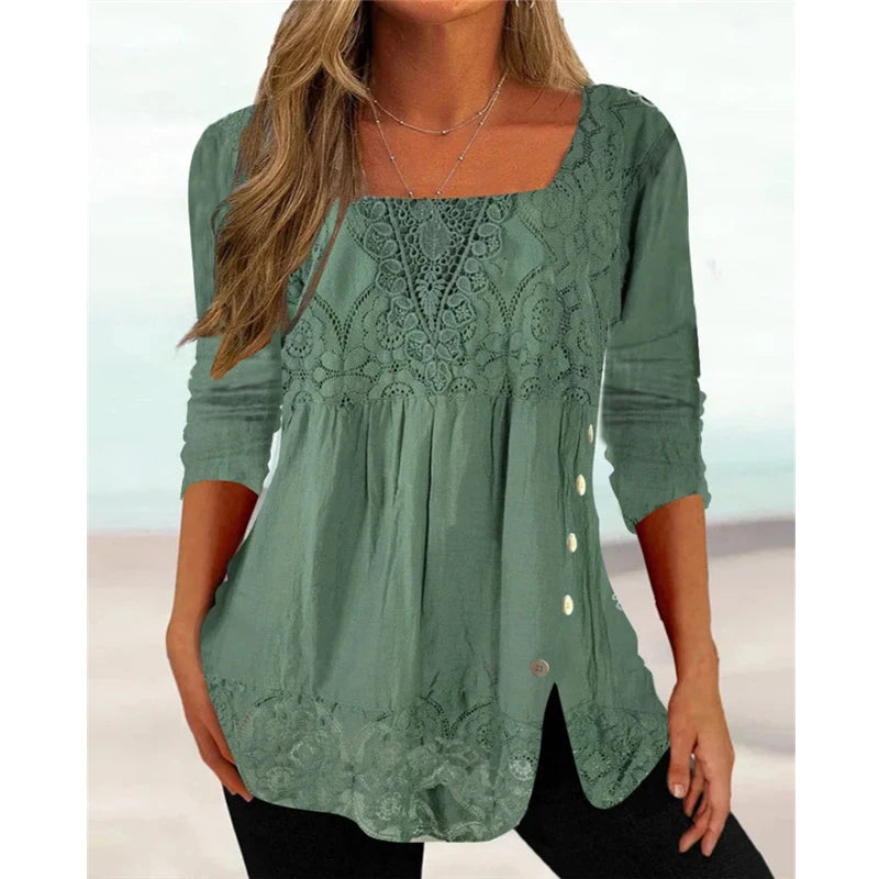 Green lace top worn by a person with a blurred background