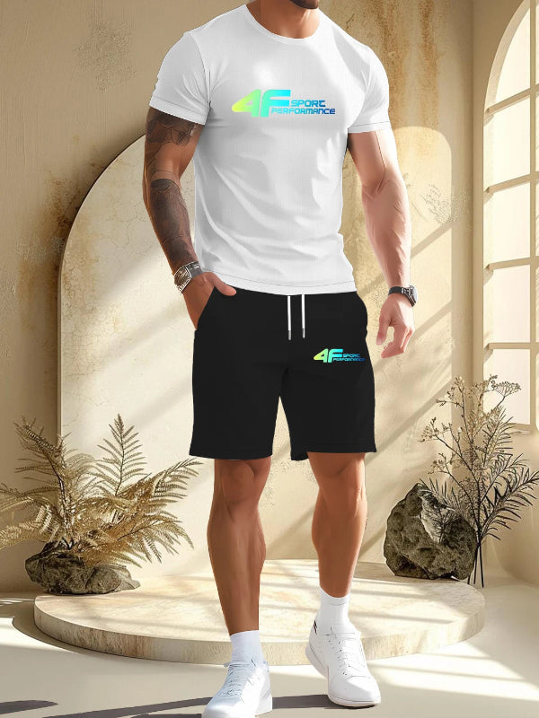 Person wearing a white t-shirt and black shorts with a brand logo, standing in a sunlit room.