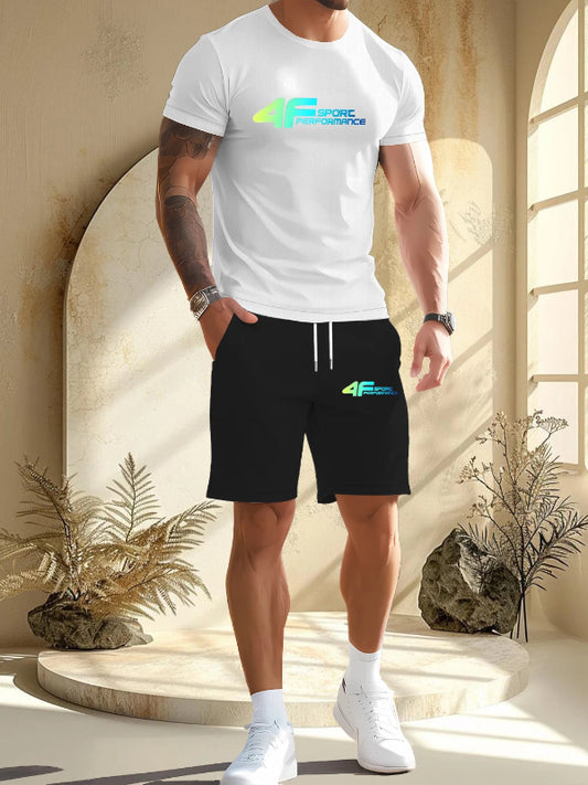 Person wearing a white t-shirt and black shorts with a brand logo, standing in a sunlit room.