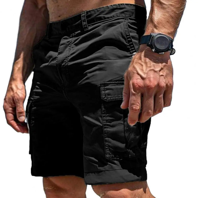 Black cargo shorts worn by a person on a white background